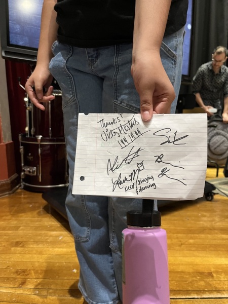 Student at Jazz for the Schools asks for musicians' autographs