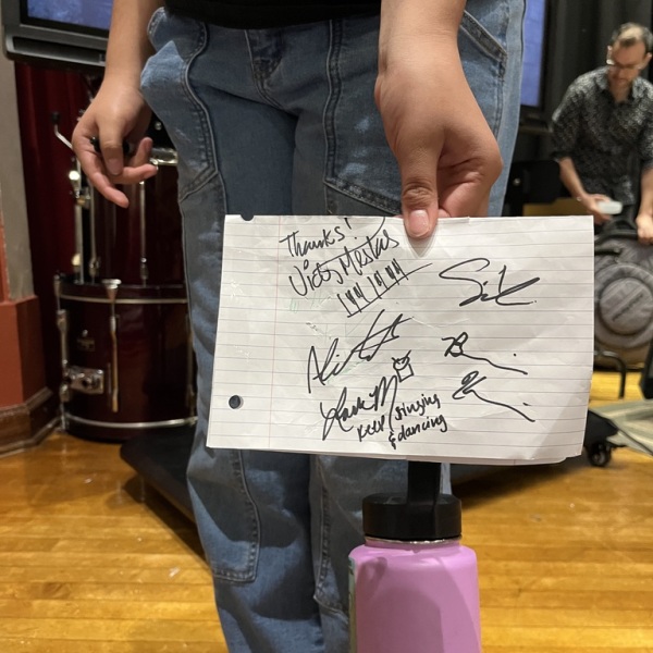 Student at Jazz for the Schools asks for musicians' autographs